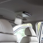 Overhead DVD player installed in a vehicle with sunroof